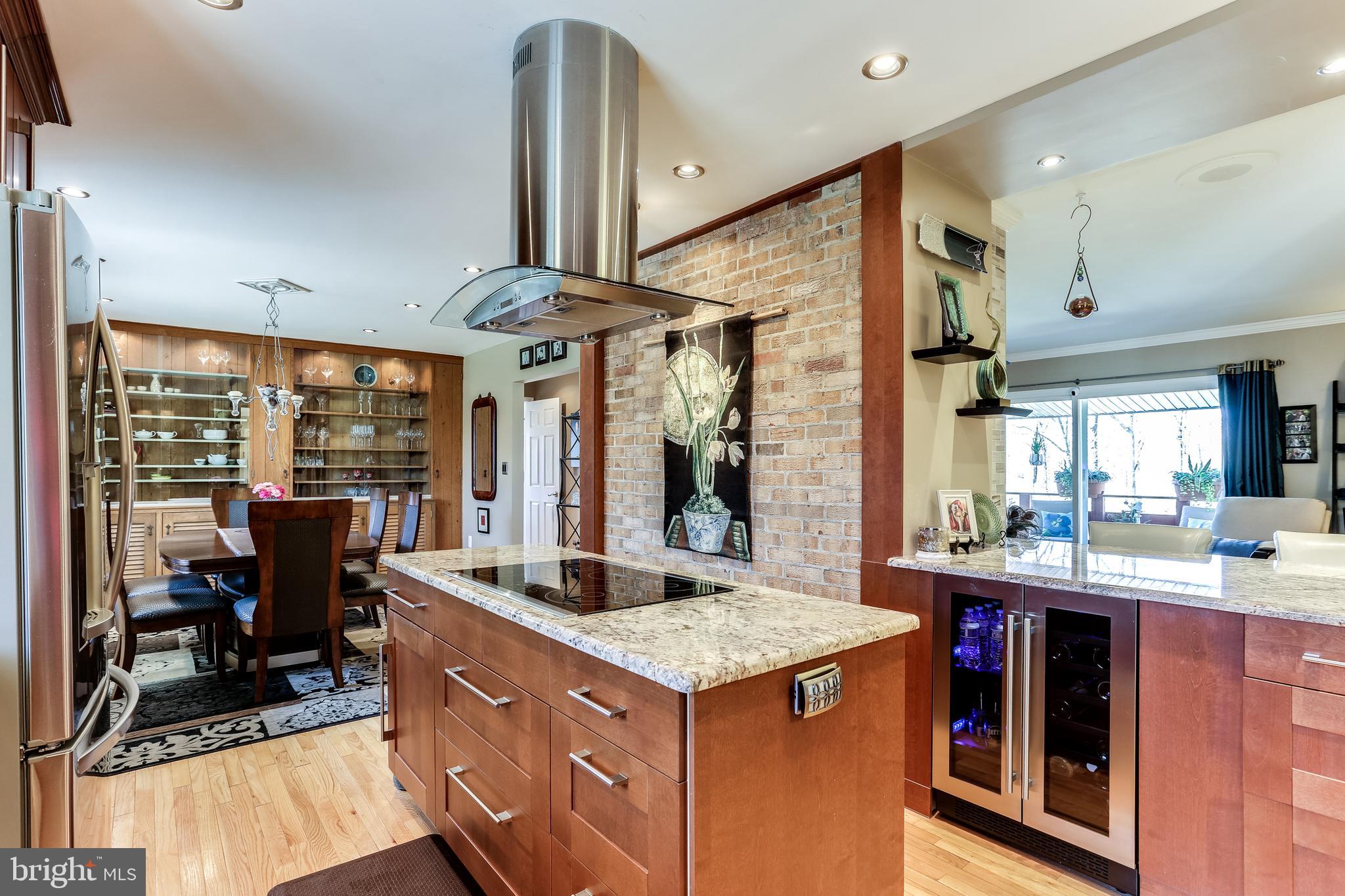 6412 Lochridge Road Columbia, MD 21044 - Photo 9 of 53 Kitchen with Center Cooktop & Wine Refrigerator