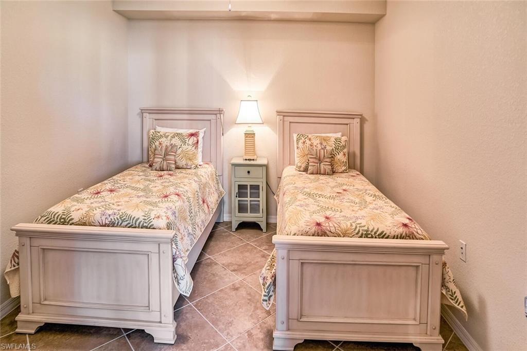 9719 Acqua Court, Unit 228 Naples, FL 34113 - Photo 14 of 35 a bedroom with a bed and a window