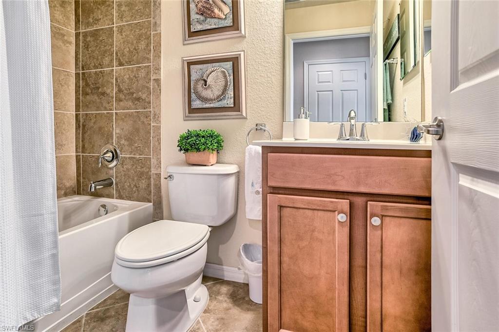 9719 Acqua Court, Unit 228 Naples, FL 34113 - Photo 15 of 35 a bathroom with a sink toilet and shower