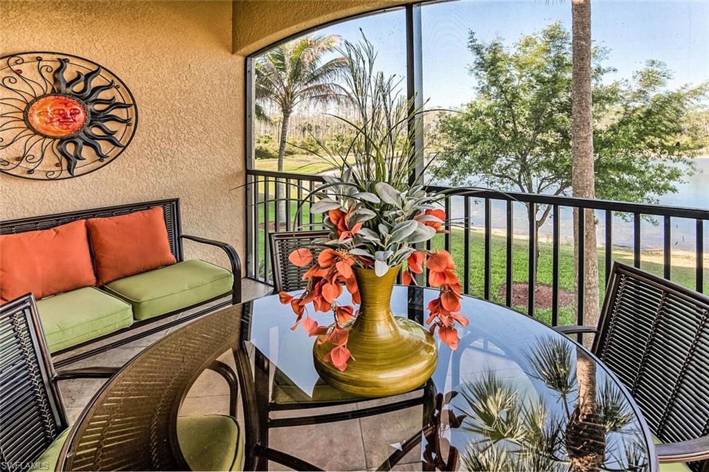 9719 Acqua Court, Unit 228 Naples, FL 34113 - Photo 17 of 35 a balcony with furniture and wooden floor