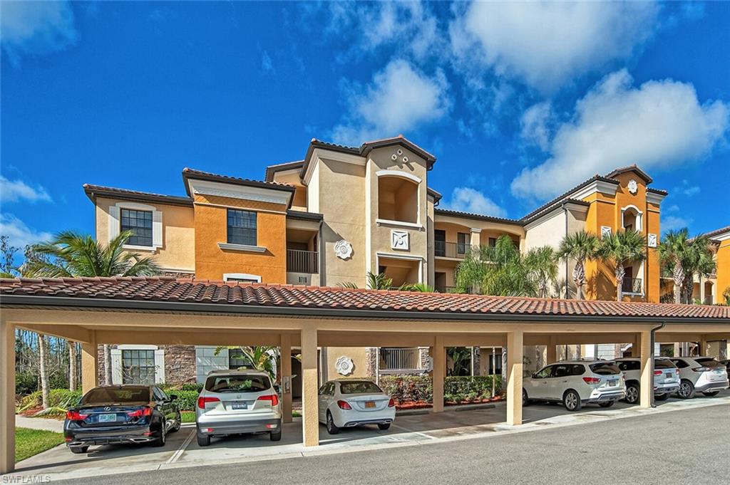 9719 Acqua Court, Unit 228 Naples, FL 34113 - Photo 2 of 35 a car parked in front of a building