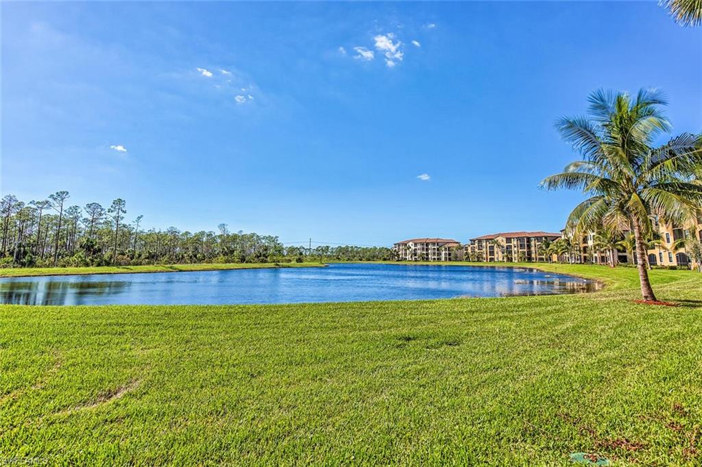 9719 Acqua Court, Unit 228 Naples, FL 34113 - Photo 21 of 35 a view of a lake with a big yard
