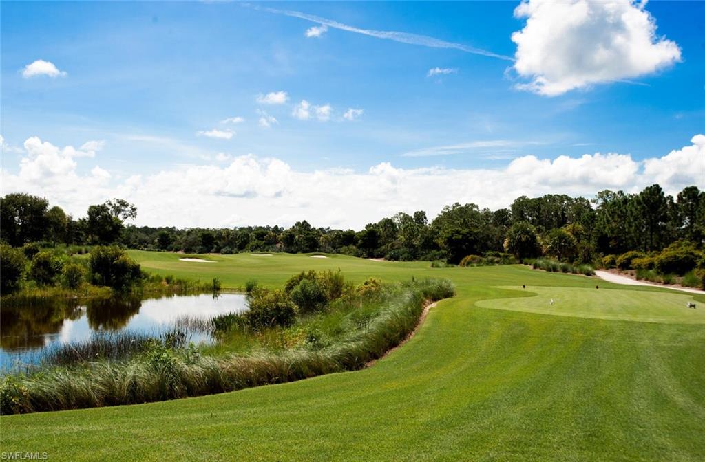 9719 Acqua Court, Unit 228 Naples, FL 34113 - Photo 28 of 35 a view of a golf course with a lake