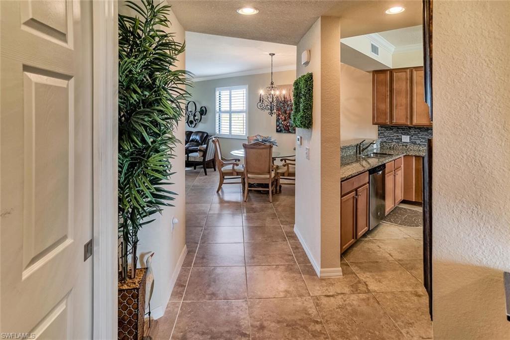 9719 Acqua Court, Unit 228 Naples, FL 34113 - Photo 3 of 35 a view of a hallway with seating area