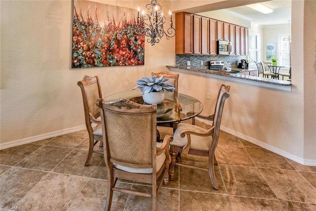 9719 Acqua Court, Unit 228 Naples, FL 34113 - Photo 6 of 35 a dining room with furniture and a floor to ceiling window