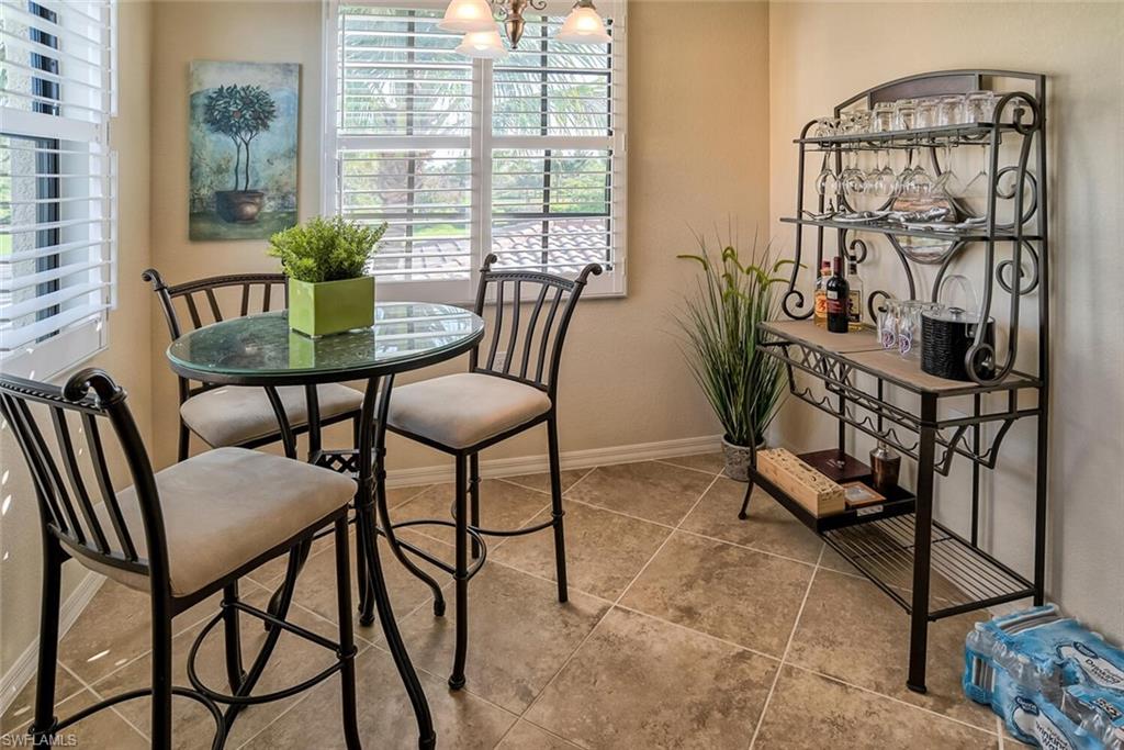 9719 Acqua Court, Unit 228 Naples, FL 34113 - Photo 9 of 35 a view of a dining room with furniture and a window