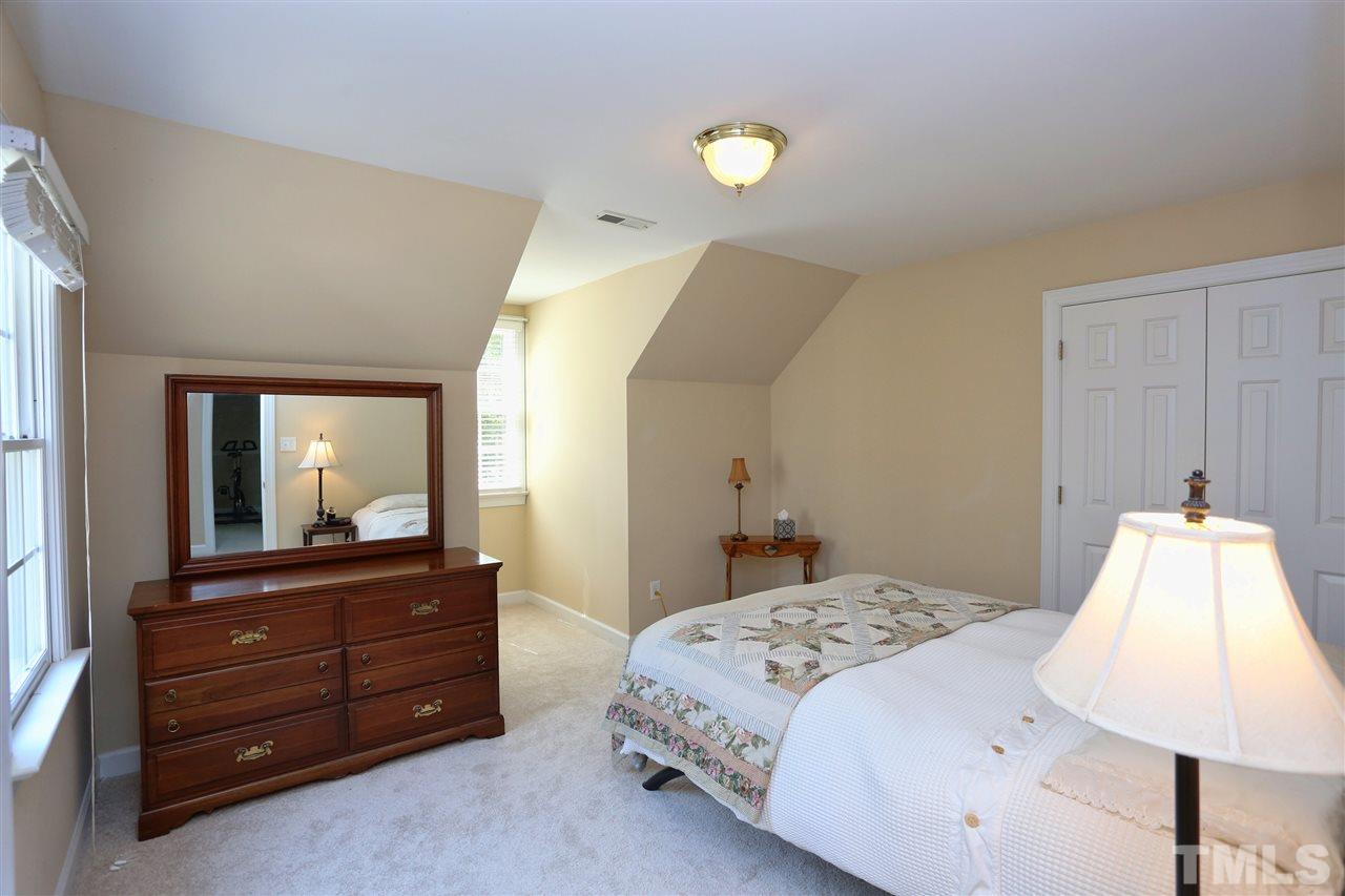 202 Manor Ridge Road Carrboro, NC 27510 - Photo 12 of 25 a bedroom with a bed and a large mirror on dresser