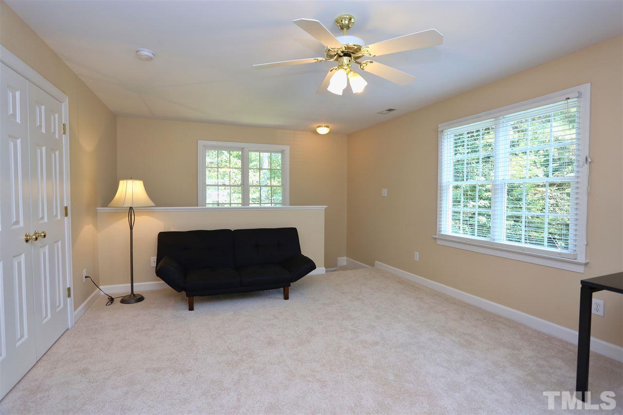 202 Manor Ridge Road Carrboro, NC 27510 - Photo 17 of 25 a living room with a bed furniture and a window