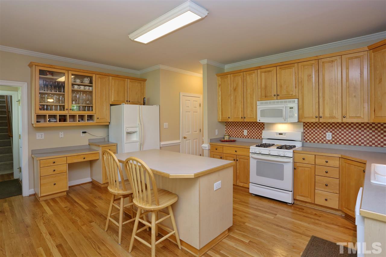 202 Manor Ridge Road Carrboro, NC 27510 - Photo 6 of 25 a kitchen with stainless steel appliances granite countertop a stove a sink dishwasher and a refrigerator with wooden cabinets