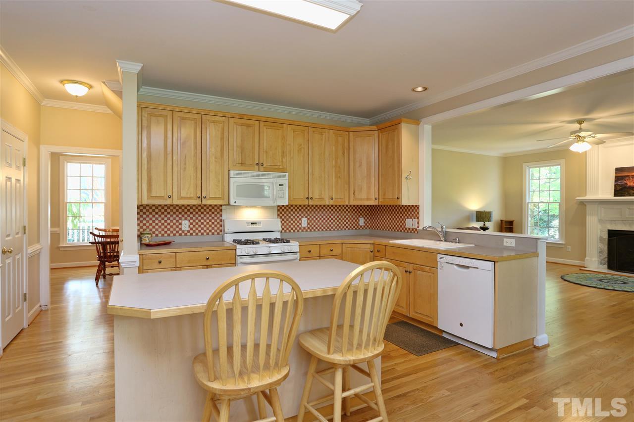 202 Manor Ridge Road Carrboro, NC 27510 - Photo 7 of 25 a kitchen with a table chairs sink and cabinets