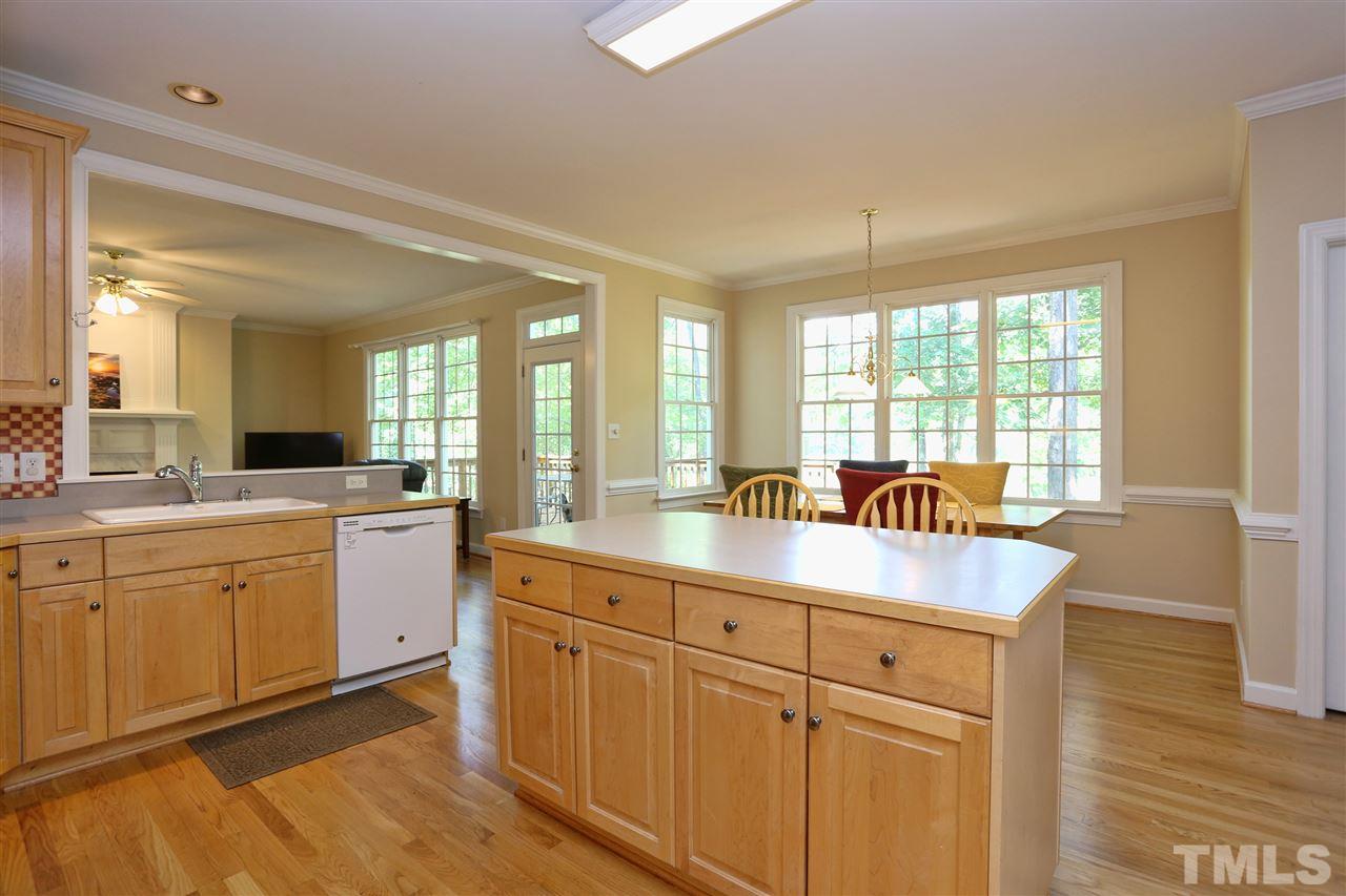 202 Manor Ridge Road Carrboro, NC 27510 - Photo 9 of 25 a kitchen with granite countertop a sink and white cabinets