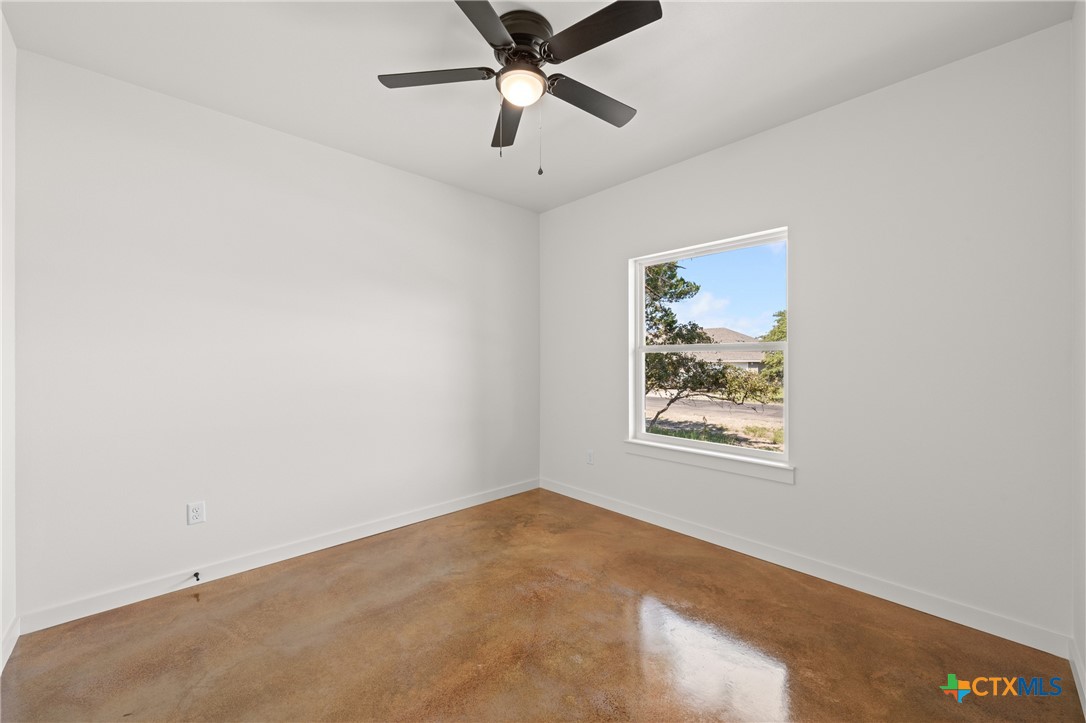 5165 Comanche Drive Temple, TX 76502 - Photo 9 of 41 an empty room with a window and a ceiling fan