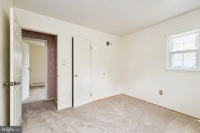 a bedroom with a bed and a curtain