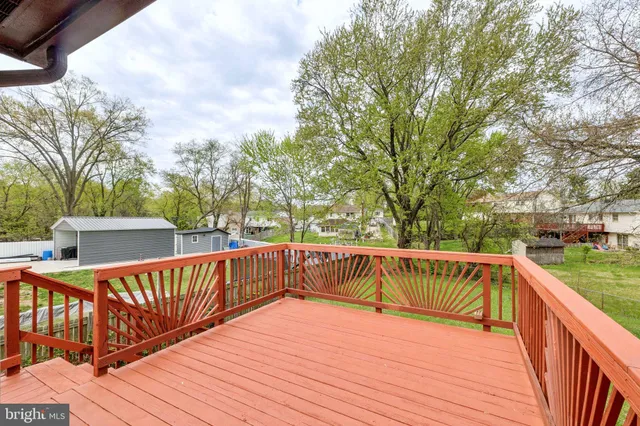 a view of a house with a wooden deck