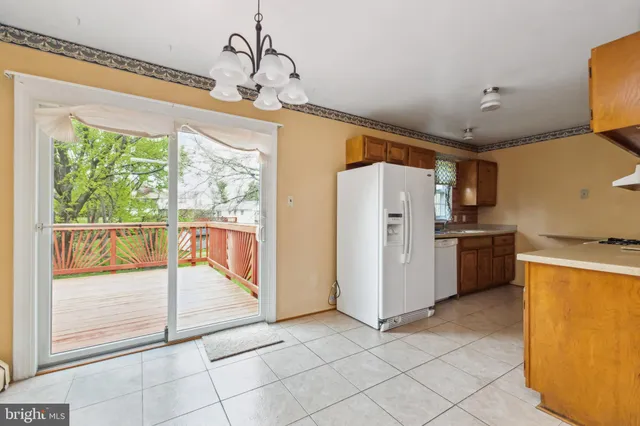 a view of a kitchen with a sink and refrigerator