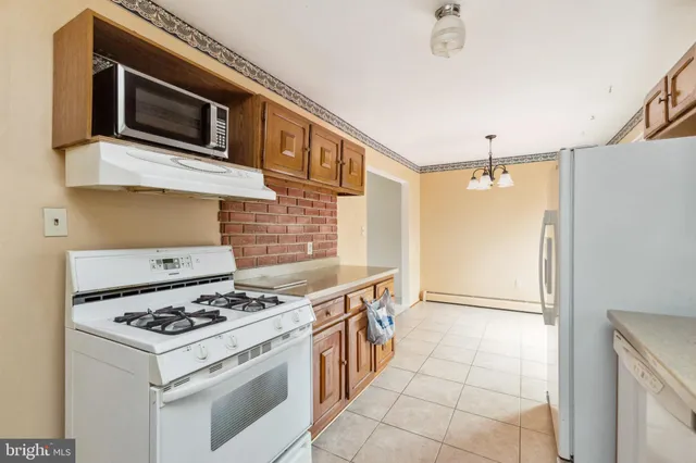 a kitchen with stainless steel appliances a stove a microwave and a refrigerator
