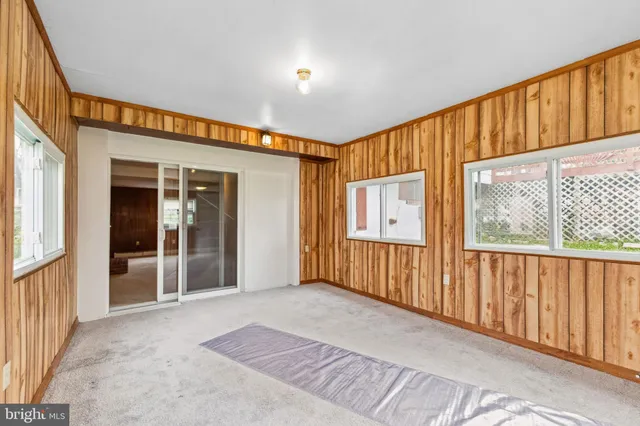 a bathroom with a sink mirror toilet and next to a window