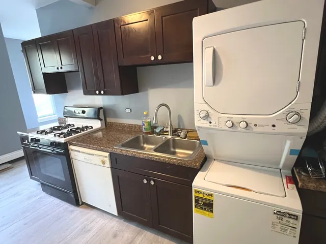 a kitchen with a stove a sink and a microwave