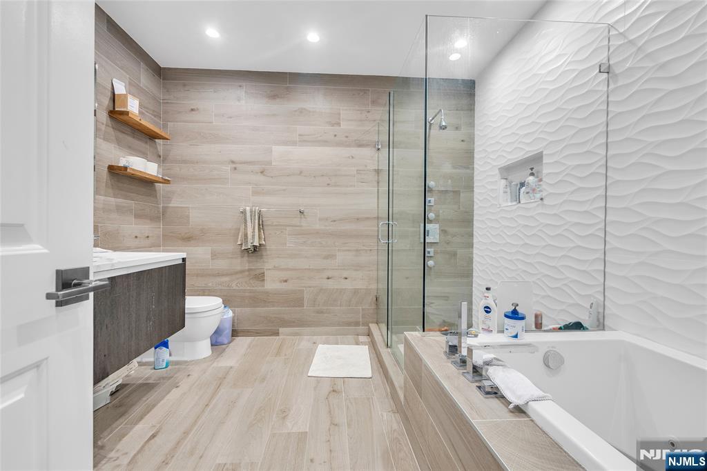 314 The Promenade Edgewater, NJ 07020 - Photo 24 of 37 a bathroom with a bathtub and a shower