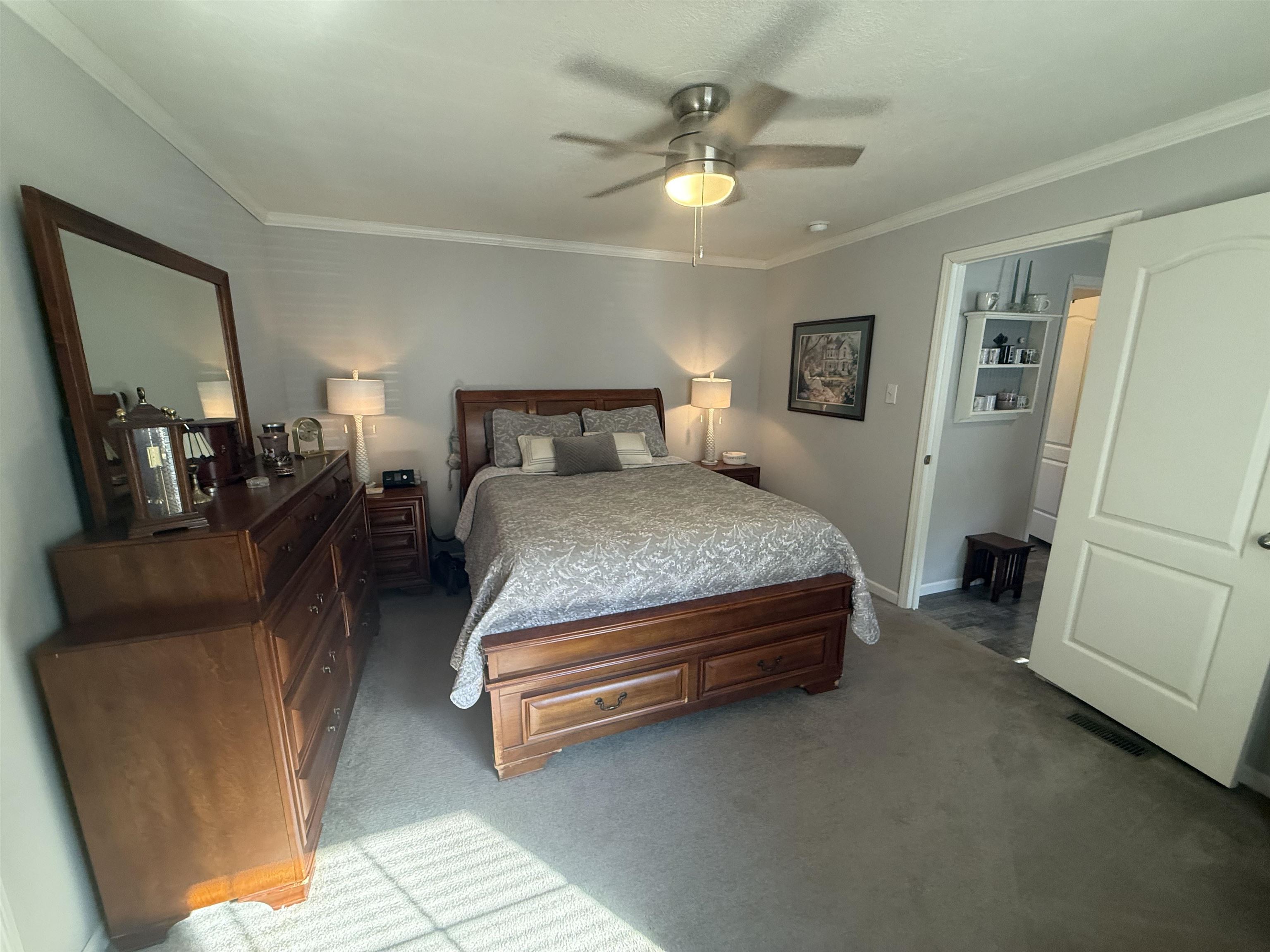185 Pine Tree Road Moscow, TN 38057 - Photo 17 of 36 Carpeted room with a ceiling fan light fixture and crown molding