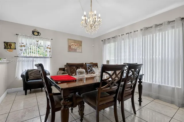 a view of a dining room with furniture and chandelier