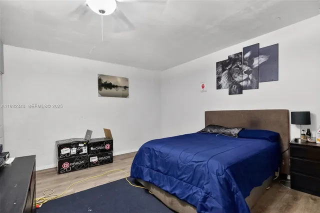 a bedroom with a bed and a flat tv screen on dresser