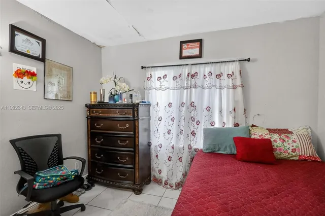 a bedroom with a bed and a view of bathroom