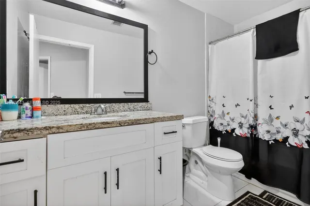 a bathroom with a sink a mirror and a toilet