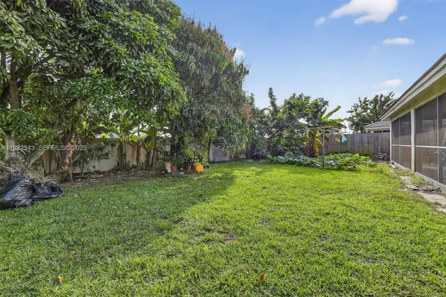 a view of an house with backyard space and garden