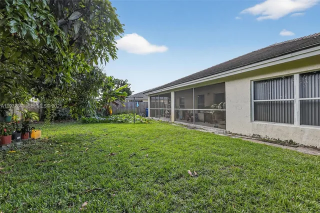 a view of a house with a backyard