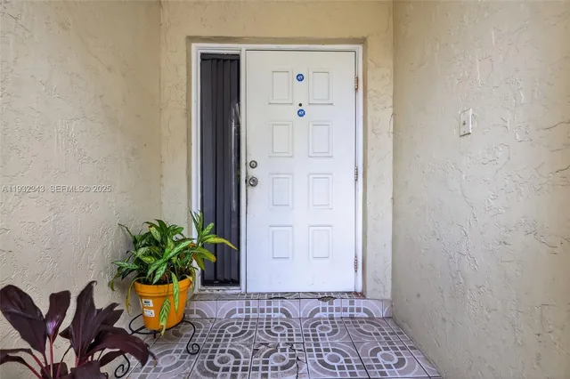 a living room with furniture and a kitchen view