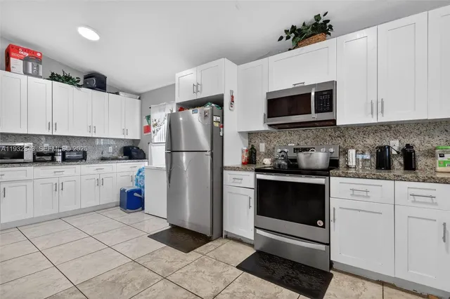 a spacious en suite bathroom with a double vanity sink and a mirror