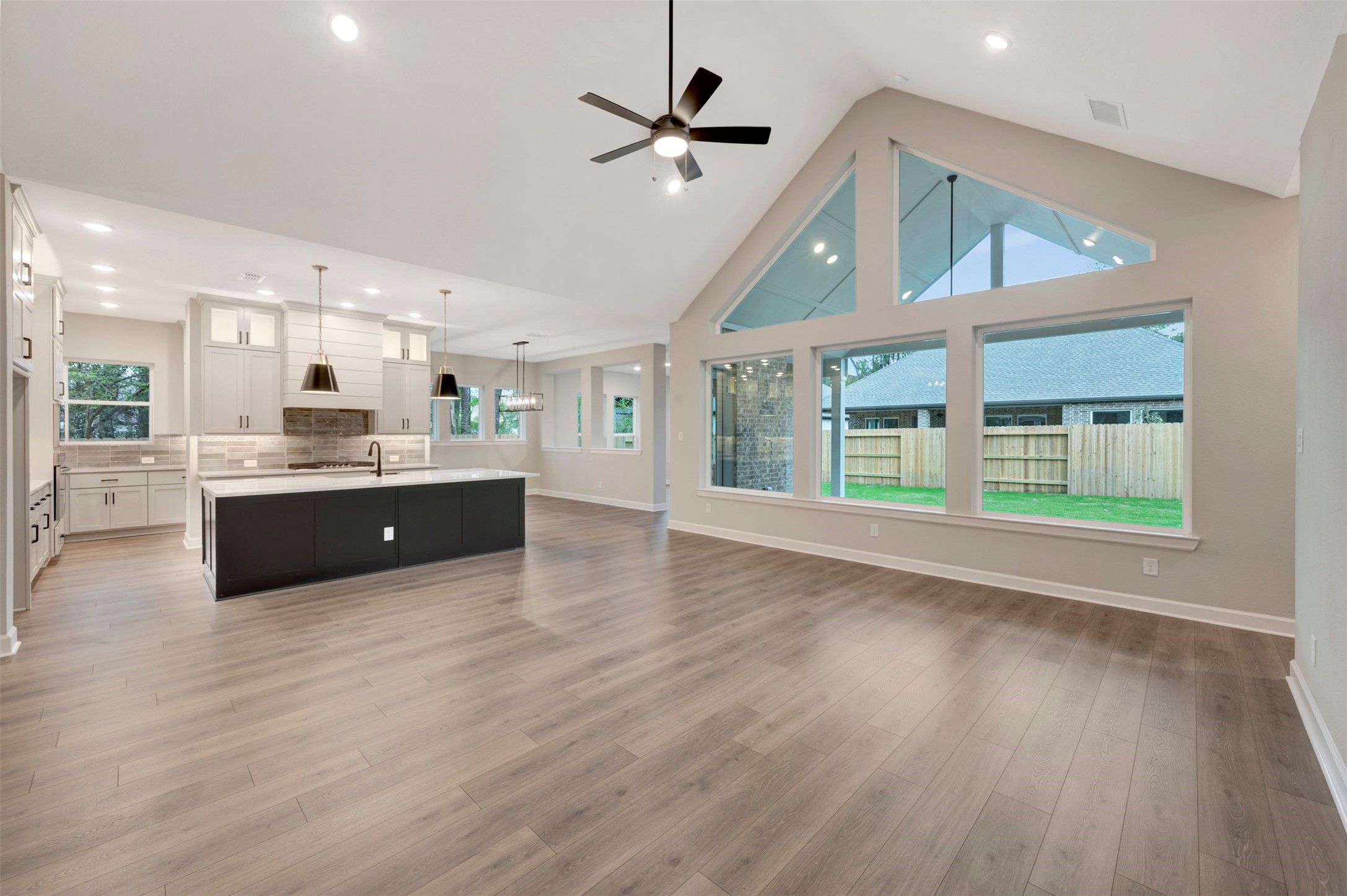 15722 Terracotta Terrace Conroe, TX 77302 - Photo 36 of 50 a large kitchen with stainless steel appliances a large window a oven and a refrigerator