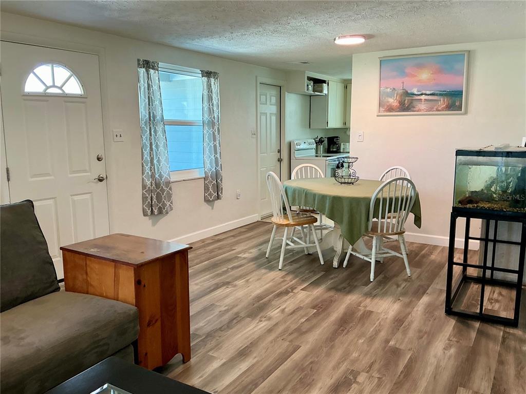 3020 Hawthorne Street Sarasota, FL 34239 - Photo 3 of 22 a view of a dining room with furniture and wooden floor