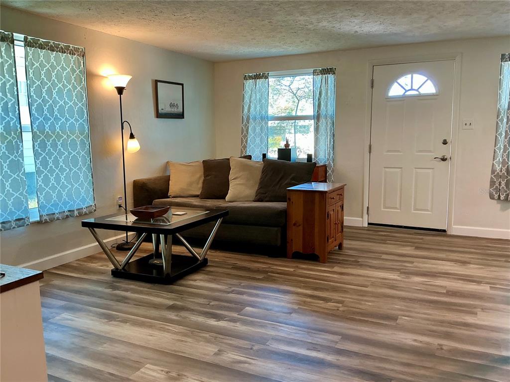 3020 Hawthorne Street Sarasota, FL 34239 - Photo 6 of 22 a living room with furniture a window and wooden floor