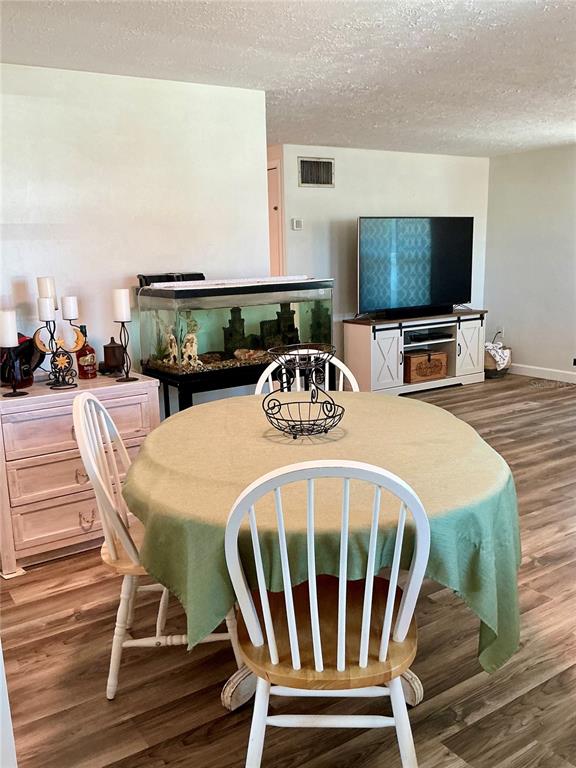 3020 Hawthorne Street Sarasota, FL 34239 - Photo 7 of 22 a dining room with furniture and a flat screen tv