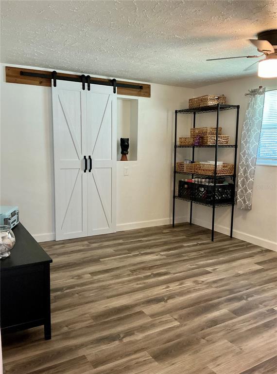 3020 Hawthorne Street Sarasota, FL 34239 - Photo 8 of 22 a view of empty room with wooden floor and fan