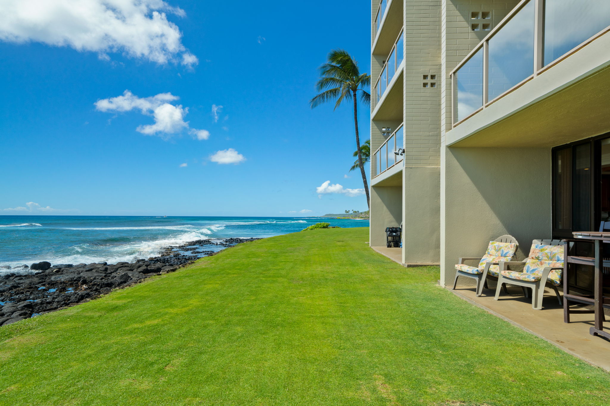 5050 Lawai Road, Unit 113 Koloa, HI 96756 - Photo 16 of 18 a view of a house with a backyard
