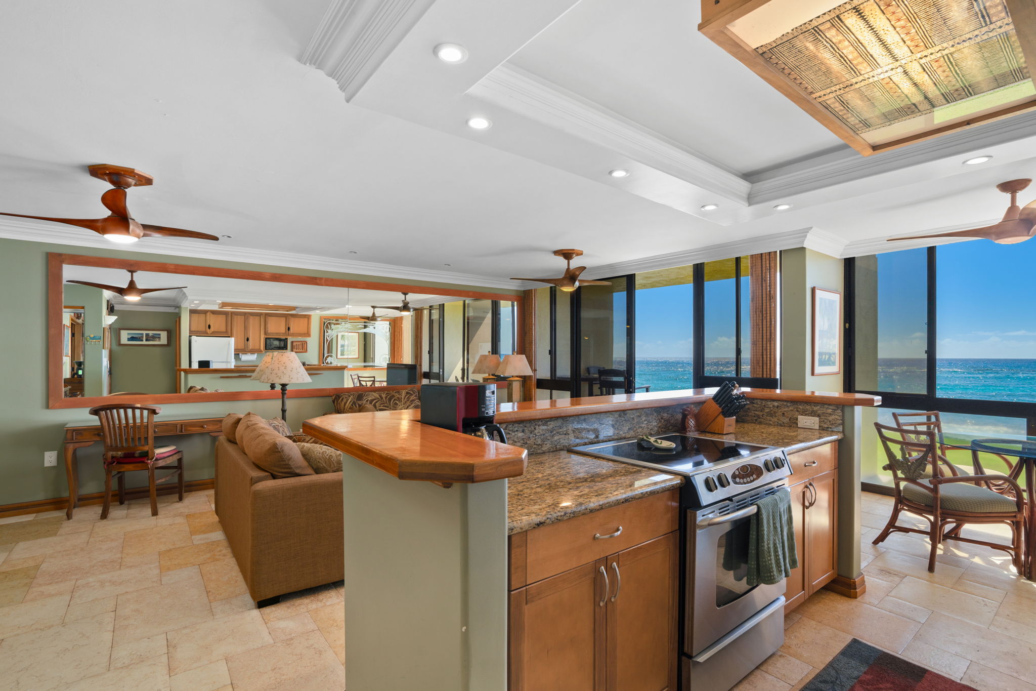 5050 Lawai Road, Unit 113 Koloa, HI 96756 - Photo 6 of 18 a kitchen with stainless steel appliances granite countertop a stove and a refrigerator
