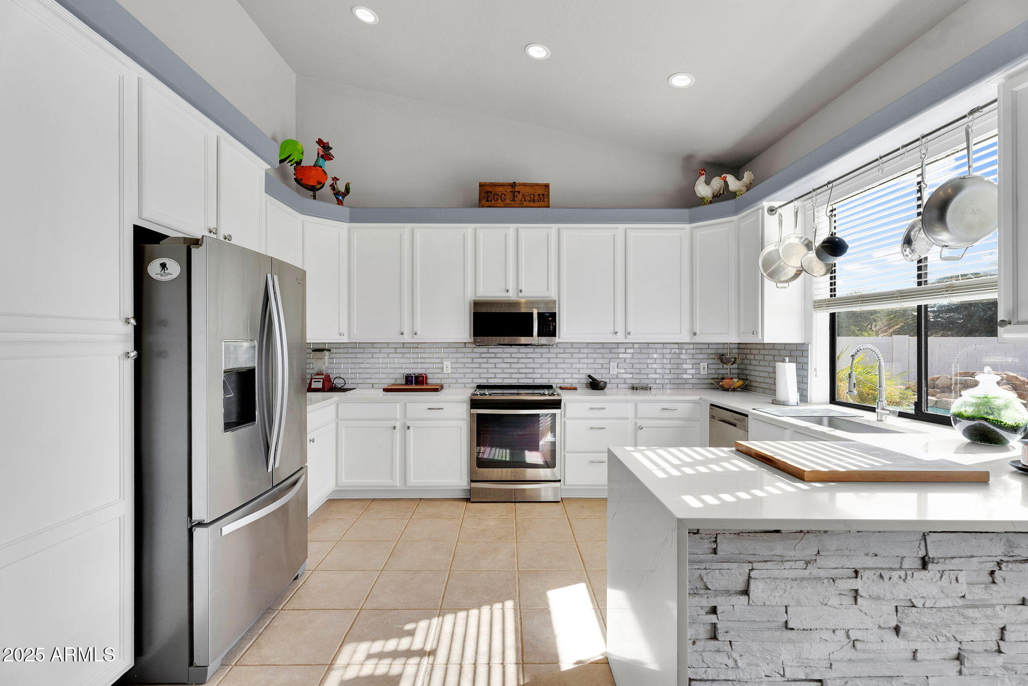 907 East Carlise Road Phoenix, AZ 85086 - Photo 12 of 70 a kitchen with granite countertop a refrigerator and a stove top oven