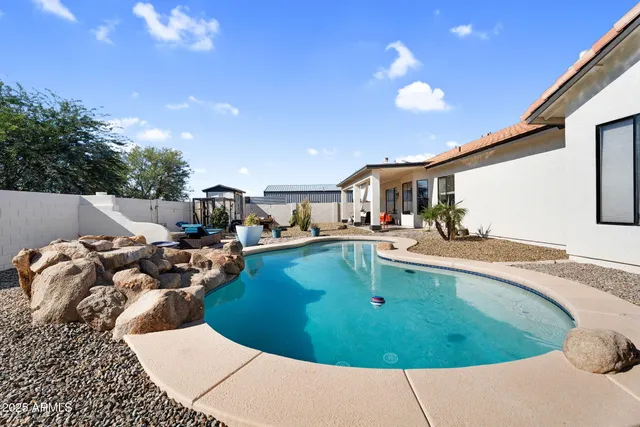 a view of a swimming pool with a patio