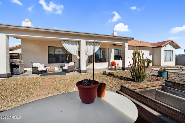 a view of a flesh room with furniture and floor to ceiling window
