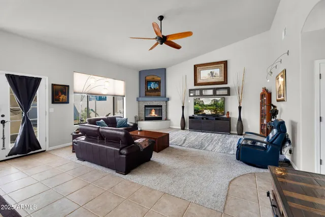 a living room with furniture a fireplace and a flat screen tv