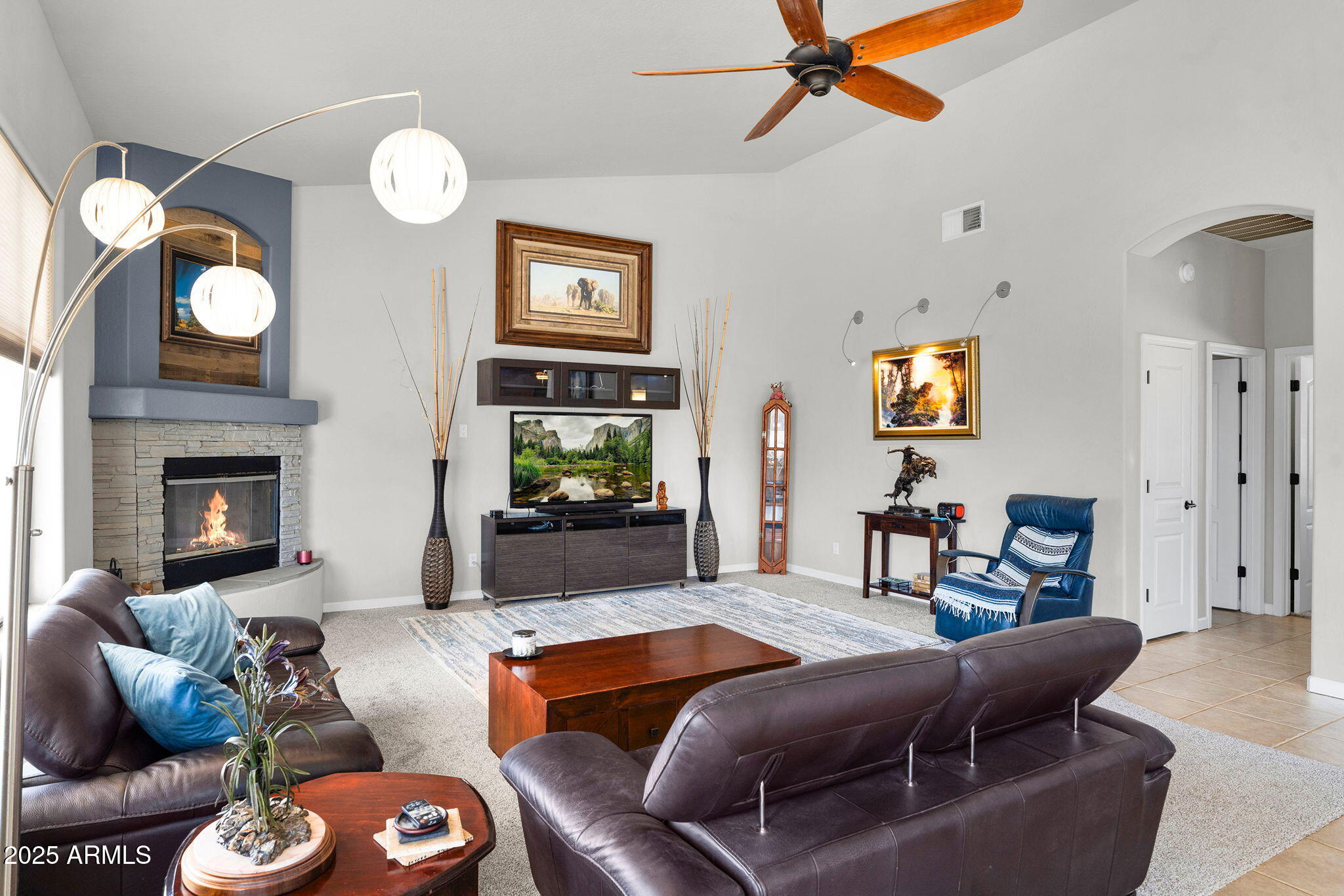 907 East Carlise Road Phoenix, AZ 85086 - Photo 5 of 70 a living room with furniture a fireplace and a flat screen tv