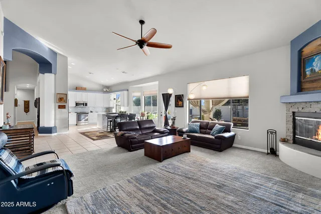a living room with furniture a desk and chair with wooden floor