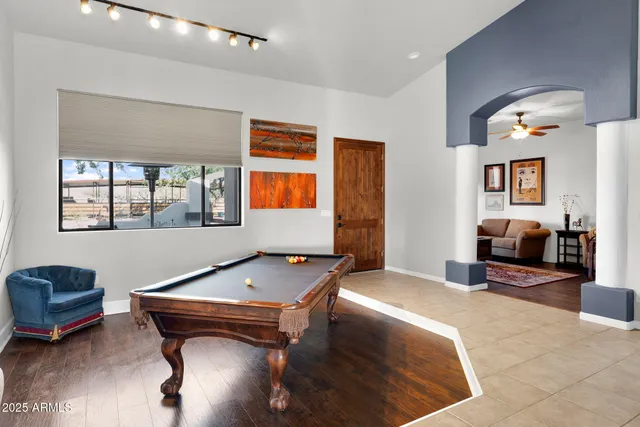 a room with furniture pool table and window