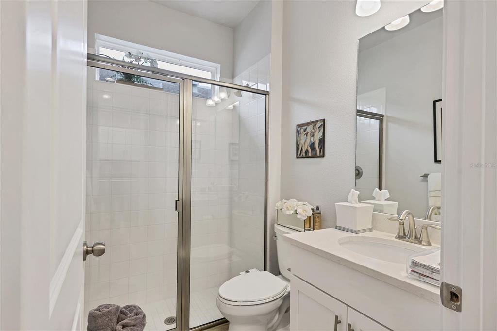 8733 Rain Song Road Sarasota, FL 34238 - Photo 17 of 39 a bathroom with a sink a toilet and shower