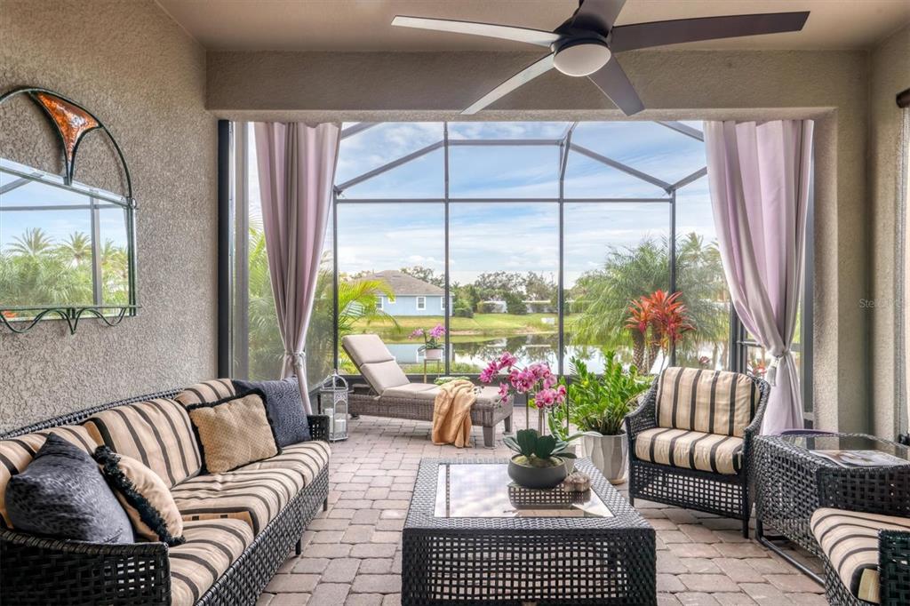 8733 Rain Song Road Sarasota, FL 34238 - Photo 22 of 39 a living room with furniture and a large window