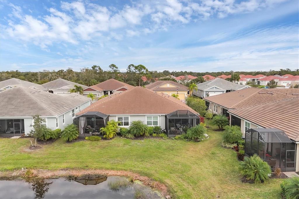 8733 Rain Song Road Sarasota, FL 34238 - Photo 27 of 39 an aerial view of residential houses with outdoor space and trees