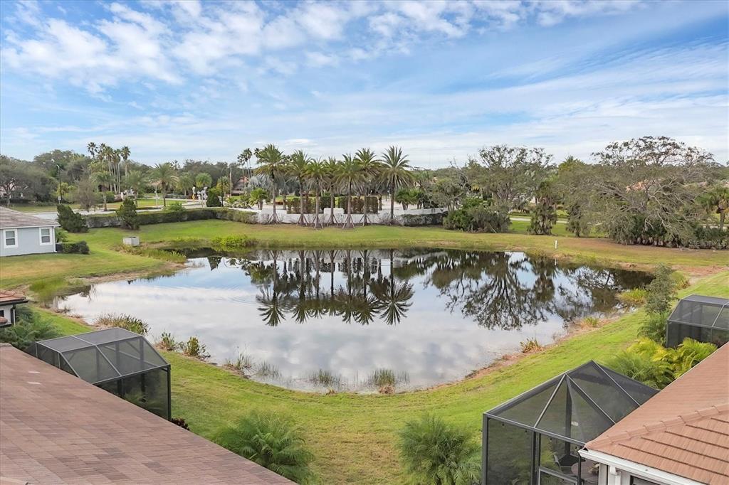 8733 Rain Song Road Sarasota, FL 34238 - Photo 29 of 39 a view of a lake with a yard and large trees